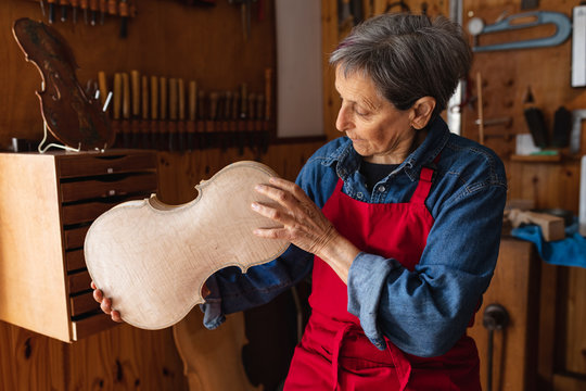 Female luthier at work in a workshop