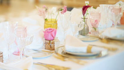 Elegant dinner table set with silverware, napkin and glass at restaurant before party