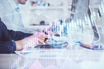 Fototapeta premium Forex graph with businessman working on computer in office on background. Concept of hardworking. Closeup. Multi exposure.