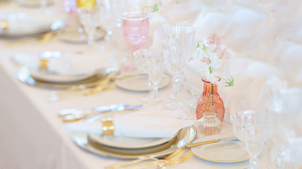 Elegant dinner table set with silverware, napkin and glass at restaurant before party