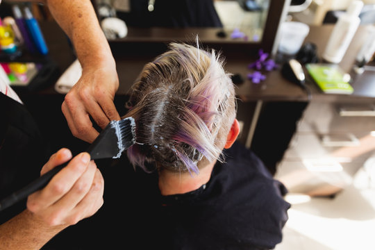 Male hairdresser and female client in hair salon