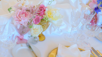 Elegant dinner table set with silverware, napkin and glass at restaurant before party
