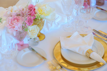 Elegant dinner table set with silverware, napkin and glass at restaurant before party