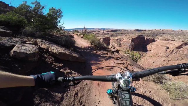Riding A Narrow Trail On A Mountain Bike