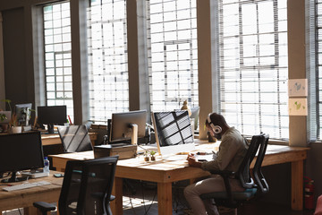 Young creative professional man working in a sunlit office
