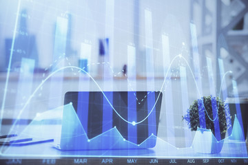 Forex Chart hologram on table with computer background. Multi exposure. Concept of financial markets.