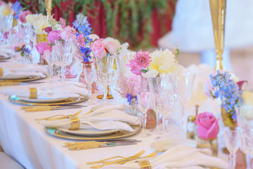 Elegant dinner table set with silverware, napkin and glass at restaurant before party