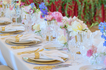 Elegant dinner table set with silverware, napkin and glass at restaurant before party