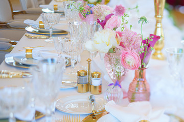 Elegant dinner table set with silverware, napkin and glass at restaurant before party