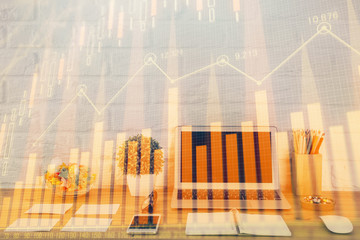 Financial graph colorful drawing and table with computer on background. Multi exposure. Concept of international markets.