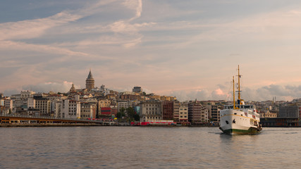 Fototapeta premium Panorama of Istanbul with Galata Tower. Entrance of Golden Horn at sunrise. Galata Bridge and cruise ships. Turkey country 