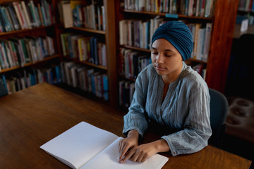 Young woman studying in library