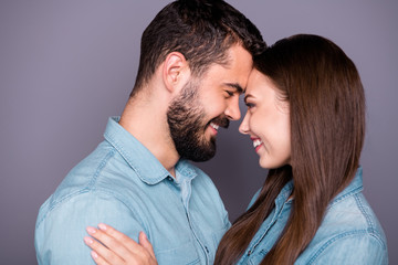 Close-up profile side view portrait of two her she his he nice attractive charming lovely affectionate careful sweet cheerful cheery person embracing cuddling isolated over gray pastel background