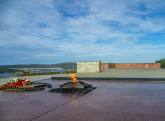 The eternal flame in the memorial complex on the Kola Peninsula on a sunny day in early autumn.