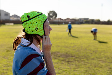 Young adult female rugby player on a rugby pitch