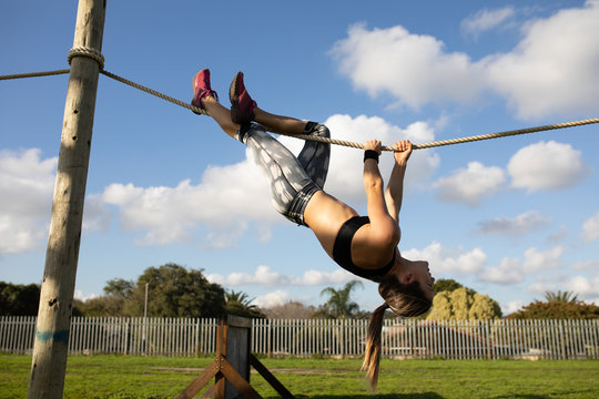Young woman training at an outdoor gym bootcamp - Powered by Adobe