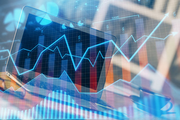 Financial chart drawing and table with computer on background. Multi exposure. Concept of...