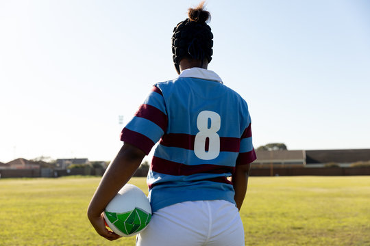 Young adult female rugby player on a rugby pitch