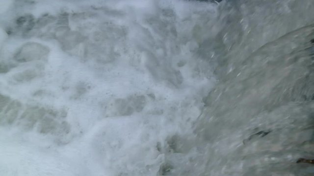 slow motion river currents under the bridge during the day