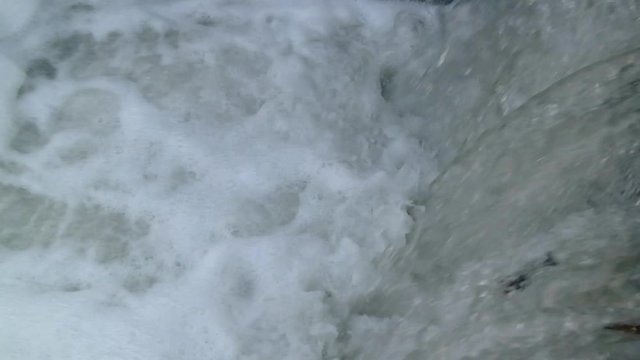 slow motion river currents under the bridge during the day