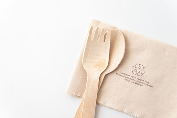 Recycle eco friendly disposable wood spoon fork and napkin paper in top view isolated on white...