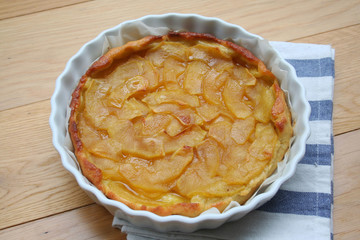 Traditional apple tart tatin on wooden background. Caramelized french apple pastry or pie 