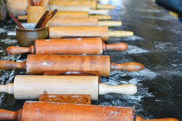 Rolling pins on a kitchen counter sprinkled with flour. Traditional old bakery. Baking concept