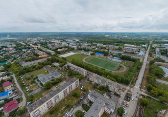 Stadium in Sukhoy Log city. Aerial, summer, cloudy day