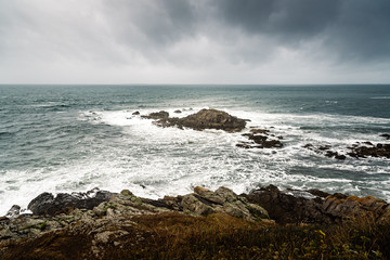 Scenic view of cliffs and sea against sky