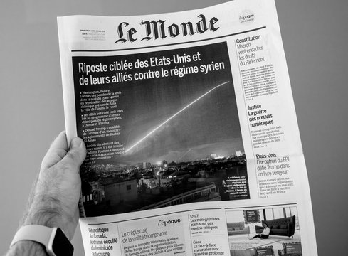 PARIS, FRANCE - APR 15, 2014: Le Monde French Newspaper In Man Hand With Cover Showing Bombing Syria Missle By Washington, London And Paris - Black And White
