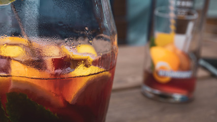 glass of whiskey and ice on wooden table