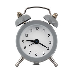 A gray clock with an alarm clock on a white background with arrows showing the time nine hours twenty minutes or twenty one hour twenty minutes