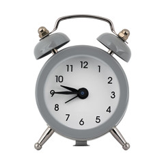 A gray clock with an alarm clock on a white background with arrows showing the time nine hours forty five minutes or twenty one hours forty five minutes