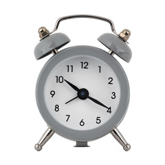 A gray clock with an alarm clock on a white background with arrows showing the time ten hours twenty minutes or twenty two hours twenty minutes