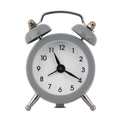 A gray clock with an alarm clock on a white background with arrows showing the time eleven hours twenty minutes or twenty three hours twenty minutes