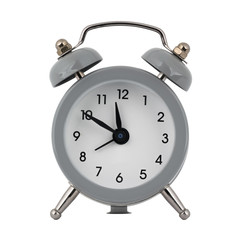 A gray clock with an alarm clock on a white background with arrows showing the time eleven hours and fifty minutes or twenty three hours and fifty minutes
