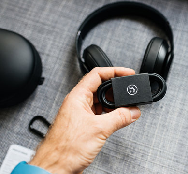 PARIS, FRANCE - MAR 31, 2018: Man unboxing new Apple Beats By Dr Dre Beats Studio 3 Wireless headphones with Pure Adaptive Noise Canceling Pure ANC 3,5 jack cable