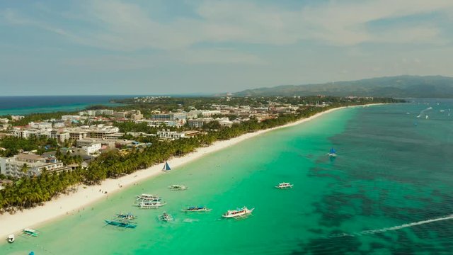 Beautiful lagoon with boats and tourist beach. White beach on the island of Boracay, top view. Seascape in sunny weather.