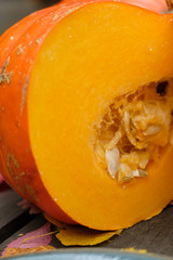 Orange pumpkins on a wooden table in the autumn landscape