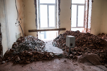 Broken brick and rubbish next to an old ruined building. Dump. Urban economy.