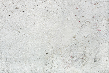 abstract background of a shabby old concrete wall painted in white close up