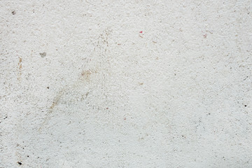 abstract background of a shabby old concrete wall painted in white close up