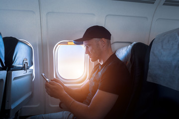 A man in the cabin sitting with a smartphone