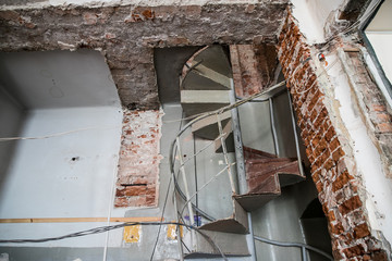 Broken brick and rubbish next to an old ruined building. Dump. Urban economy.