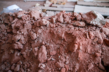 Broken brick and rubbish next to an old ruined building. Dump. Urban economy.
