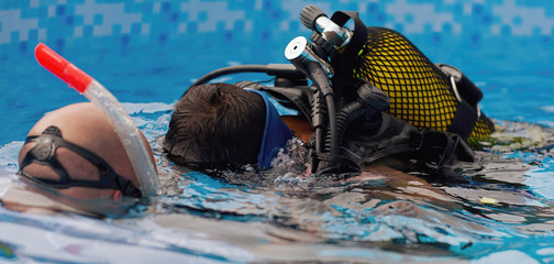 Scuba diving lesson with children trainee and instructor