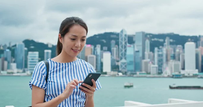 Woman use of smart phone in city of Hong Kong