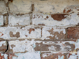 rounded Old dirty brickwork arch. White ruined whitewash. Background texture. Scratches and bumps