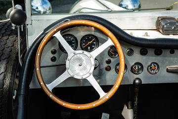 Close Up of Oldtimer Wooden Wheel and Dashboard