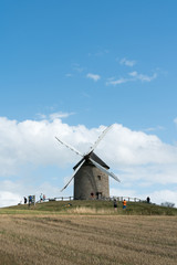 Fototapeta na wymiar tourists visit the famous and historic Moidrey Windmill near Le Mont Saint-Michel in France